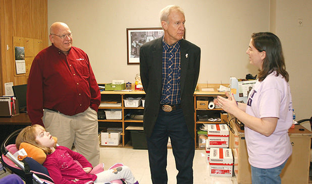 Gov. Bruce Rauner stopped at The Journal-News office in Hillsboro on Friday afternoon and while there, met Grace Herschelman and learned about Infantile Neuroaxonal Dystrophy (INAD). From the left are Grace, newspaper owner John Galer, Gov. Rauner and newspaper editor Mary Herschelman.