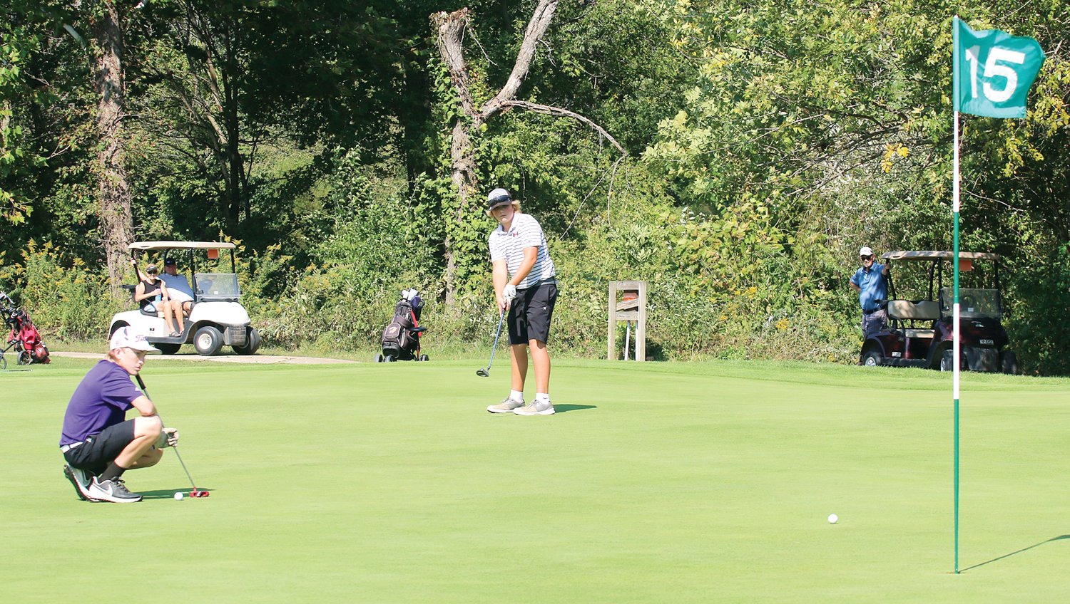 Litchfield's Brawly Jacobs watches as Tycen Thacker's putt rolls toward the hole on the 15th green at Indian Springs on Monday, Sept. 27. Thacker's Hillsboro Hilltoppers edged Jacobs' Purple Panthers for second at the South Central Conference Tournament, shooting a 327 to the Panthers' 328