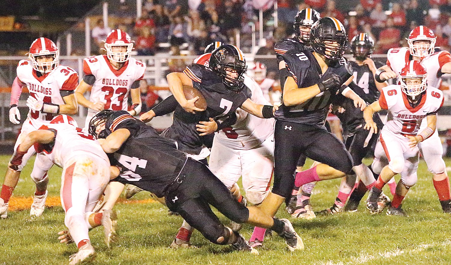 Running behind tackle Ian Malloy (#64) and guard Magnus Wells (#70), Hillsboro quarterback Zane Duff (#7) runs to daylight in the Toppers' 40-7 victory over Staunton on Friday evening, Oct. 8, at Sawyer Field.