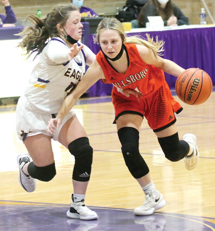 Through the suffocating pressure of the Civic Memorial defense, Hillsboro's Sierra Compton drives the lane during the Toppers' match-up with the Eagles on Friday, Nov. 26. Civic Memorial would win the game 52-33 en route to their fourth straight championship at Taylorville.